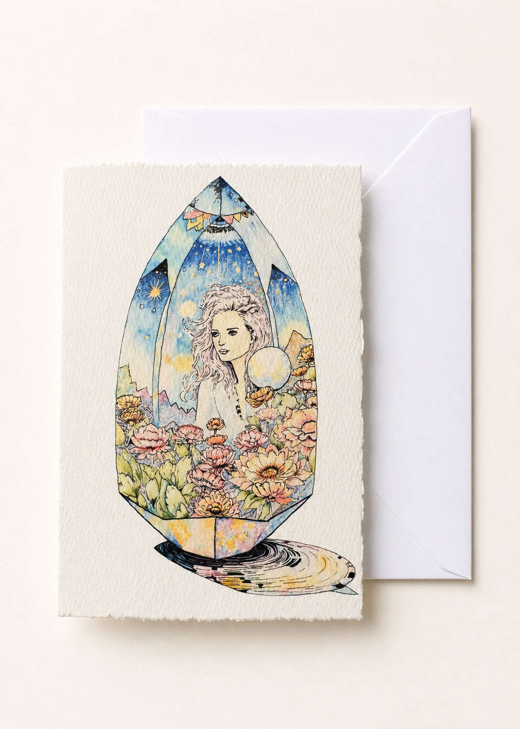 Amaréa 5x7 deckled-edge greeting card showing flower-crowned figure held inside a faceted gem with a white envelope