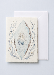 Crystalis 5x7 deckled-edge greeting card showing mermaid figure suspended inside a pale blue crystal with pearls with a white envelope
