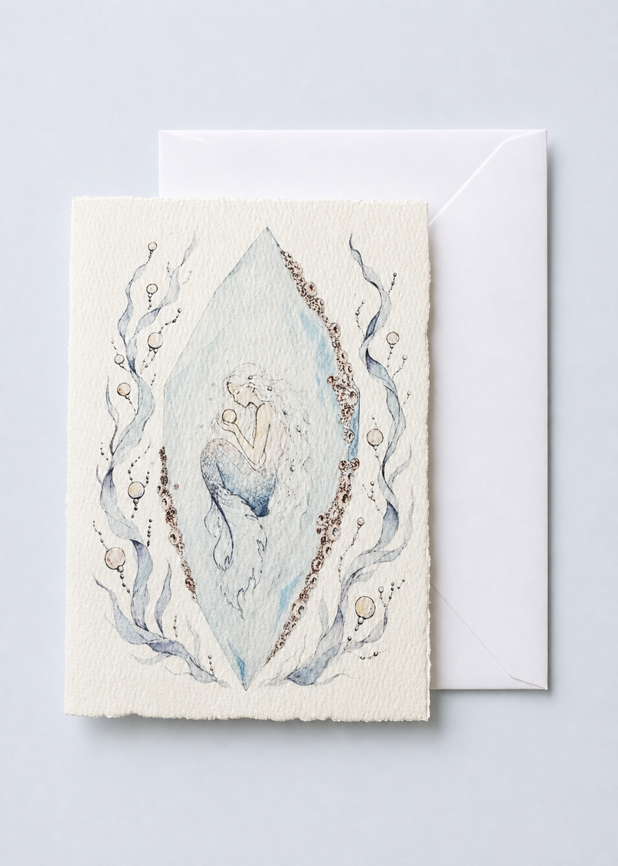 Crystalis 5x7 deckled-edge greeting card showing mermaid figure suspended inside a pale blue crystal with pearls with a white envelope